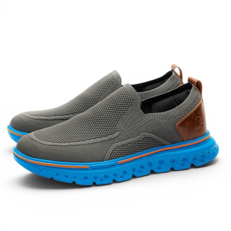 ShoeShop Uncle Paul JUSS grey knit slip-on sneakers with brown leather accents and bright blue soles.